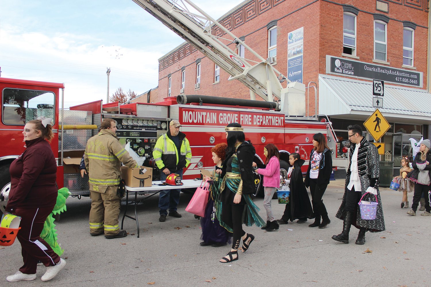 The Mountain Grove Fire Department hands out candy to trick or treaters as they brought a fire truck to the square.